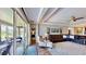 Bright living room with hardwood floors, leather seating, and sliding door to screened patio at 15510 Lake Burnett Shore Ct, Winter Garden, FL 34787