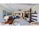 Open-concept living room features a large leather sectional sofa, ceiling fan, and stylish stone-accented wall shelving at 15510 Lake Burnett Shore Ct, Winter Garden, FL 34787
