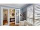 Cozy room featuring french doors, wood floors, neutral walls, large windows, and comfortable seating at 15510 Lake Burnett Shore Ct, Winter Garden, FL 34787