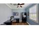 Office with hardwood floors, a sleek black desk and shelving unit and a large window at 15510 Lake Burnett Shore Ct, Winter Garden, FL 34787