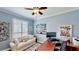 Bright office space with white sofa, shutters, and desk setup at 15510 Lake Burnett Shore Ct, Winter Garden, FL 34787