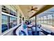 Relaxing outdoor patio with furniture and ceiling fans, overlooking a lake and pool at 15510 Lake Burnett Shore Ct, Winter Garden, FL 34787