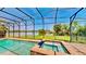 Sparkling pool and hot tub in a screened enclosure overlooking a scenic lake at 15510 Lake Burnett Shore Ct, Winter Garden, FL 34787