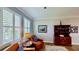Bright sitting room with two armchairs, neutral walls, and wooden floors at 15510 Lake Burnett Shore Ct, Winter Garden, FL 34787