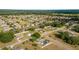 Extensive aerial view of homes in a community, featuring wide green spaces and tree-lined streets at 16190 Sw 16Th Ct, Ocala, FL 34473