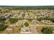 Expansive aerial view of a community featuring single-Gathering homes, green spaces, and lush trees at 16190 Sw 16Th Ct, Ocala, FL 34473