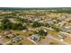 Panoramic aerial view of a neighborhood surrounded by lush greenery, with spacious lots and tidy lawns at 16190 Sw 16Th Ct, Ocala, FL 34473