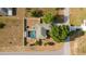 An aerial perspective showcases the property's layout, including the screened-in pool, backyard, and surrounding landscape at 16190 Sw 16Th Ct, Ocala, FL 34473