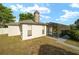 Back exterior of the home with a screened pool and large brick chimney at 16190 Sw 16Th Ct, Ocala, FL 34473