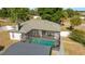 Aerial view of the backyard featuring a screened-in pool, patio area, and mature landscaping at 16190 Sw 16Th Ct, Ocala, FL 34473