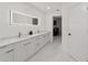 Bathroom featuring double vanity with marble countertops, a large mirror and tile flooring at 16190 Sw 16Th Ct, Ocala, FL 34473