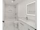 Bathroom featuring a tub and a stylish vanity with an illuminated mirror at 16190 Sw 16Th Ct, Ocala, FL 34473