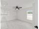 Bright bedroom featuring tile flooring, a ceiling fan, and ample natural light at 16190 Sw 16Th Ct, Ocala, FL 34473
