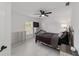 Bright bedroom featuring tiled floors, ceiling fan, and iron bed frame at 16190 Sw 16Th Ct, Ocala, FL 34473