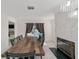 Dining room with stylish fireplace and views of the pool out of the glass windows at 16190 Sw 16Th Ct, Ocala, FL 34473