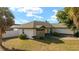 Well-maintained single-story home featuring stone accents, a new roof, manicured lawn, and mature palm trees at 16190 Sw 16Th Ct, Ocala, FL 34473