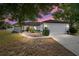 Charming single-story home with a stone accent wall, well-lit walkway, lush landscaping, and a two-car garage at 16190 Sw 16Th Ct, Ocala, FL 34473