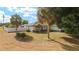 Charming single-story home with a well-manicured lawn, palm trees and a beautiful stone accent entryway at 16190 Sw 16Th Ct, Ocala, FL 34473