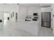 Modern kitchen features stainless steel appliances and large island with black faucet and marble counter tops at 16190 Sw 16Th Ct, Ocala, FL 34473