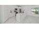 Bright kitchen featuring white cabinetry, stainless steel appliances, a center island and tile flooring at 16190 Sw 16Th Ct, Ocala, FL 34473