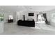 Bright, open living room with modern furnishings, recessed lighting, and tile flooring with access to the patio at 16190 Sw 16Th Ct, Ocala, FL 34473