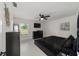 Main bedroom with lots of natural light, a TV and black furniture at 16190 Sw 16Th Ct, Ocala, FL 34473