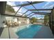 Enjoy outdoor living with a screened-in pool, dining set, and lounge chairs, perfect for Florida relaxation at 16190 Sw 16Th Ct, Ocala, FL 34473