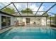 Step into your own oasis with a screened-in pool area, complete with an outdoor dining set and lounge seating at 16190 Sw 16Th Ct, Ocala, FL 34473