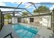 The screened-in pool has plenty of room to relax, with lounge chairs, dining, and seamless indoor-outdoor flow at 16190 Sw 16Th Ct, Ocala, FL 34473