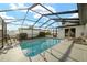 Enjoy the refreshing screened-in pool, featuring lounge chairs and outdoor rocking chairs for ultimate relaxation at 16190 Sw 16Th Ct, Ocala, FL 34473