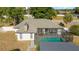Back of house showcasing a screened in pool and patio, with a well maintained roof and spacious yard at 16190 Sw 16Th Ct, Ocala, FL 34473