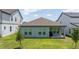 A backyard view showcasing the house's exterior, including windows and patio space at 16489 Silver Brook Way, Winter Garden, FL 34787