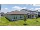 A well-maintained backyard showcasing the home's exterior and providing a serene outdoor space at 16489 Silver Brook Way, Winter Garden, FL 34787