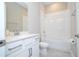 Bathroom showcasing a vanity with quartz countertop, a shower-tub combo, and modern fixtures at 16489 Silver Brook Way, Winter Garden, FL 34787