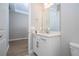 Bathroom featuring a bright vanity area, with modern fixtures and a view into the bedroom at 16489 Silver Brook Way, Winter Garden, FL 34787
