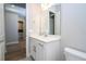 Bathroom featuring white cabinets and sink and laundry room in background at 16489 Silver Brook Way, Winter Garden, FL 34787