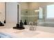 Modern bathroom sink with decorative soap and a large mirror at 16489 Silver Brook Way, Winter Garden, FL 34787