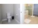 Modern bathroom features a toilet and separate shower with glass doors at 16489 Silver Brook Way, Winter Garden, FL 34787