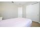 Neutral bedroom featuring white walls and sliding door closet with wood grain floors at 16489 Silver Brook Way, Winter Garden, FL 34787