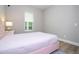 Bedroom with a pink upholstered bed and hardwood floors at 16489 Silver Brook Way, Winter Garden, FL 34787