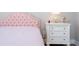 Bedroom featuring pink headboard, white nightstand, and light-colored walls at 16489 Silver Brook Way, Winter Garden, FL 34787