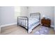 Charming bedroom with a black metal bed frame and a blue and white striped comforter at 16489 Silver Brook Way, Winter Garden, FL 34787