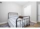 Bedroom features a black metal bed frame with coordinating striped bedding, and a built-in closet at 16489 Silver Brook Way, Winter Garden, FL 34787