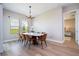 Open-concept dining room with decorative chandelier and view of the outdoors at 16489 Silver Brook Way, Winter Garden, FL 34787