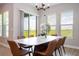 Bright dining room boasts a stylish marble table, seating for eight, and large windows offering scenic outdoor views at 16489 Silver Brook Way, Winter Garden, FL 34787
