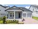 Charming single-Gathering home featuring a light blue exterior, a two-car garage, and a beautifully landscaped front yard at 16489 Silver Brook Way, Winter Garden, FL 34787