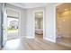 Bright, open floor plan showcasing the entry foyer with views of the bedroom, bathroom, and front door at 16489 Silver Brook Way, Winter Garden, FL 34787