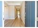 Long hallway with tray ceiling and recessed lights as viewed from front door at 16489 Silver Brook Way, Winter Garden, FL 34787