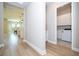 Hallway view showcasing laundry room and a glimpse of dining area, illustrating the home's layout and connectivity at 16489 Silver Brook Way, Winter Garden, FL 34787