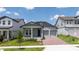 Charming gray home featuring a two-car garage, inviting front porch, and well-maintained landscaping at 16489 Silver Brook Way, Winter Garden, FL 34787